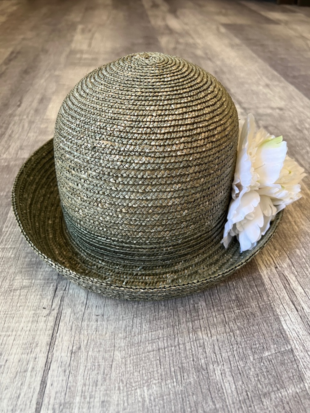betmar sage green braided straw cloche with white floral tag